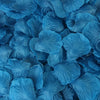A close-up view of blue artificial silk rose petals scattered in a pile.