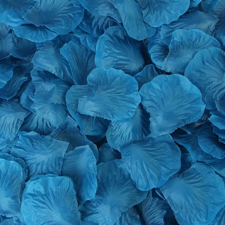 A close-up view of blue artificial silk rose petals scattered in a pile.