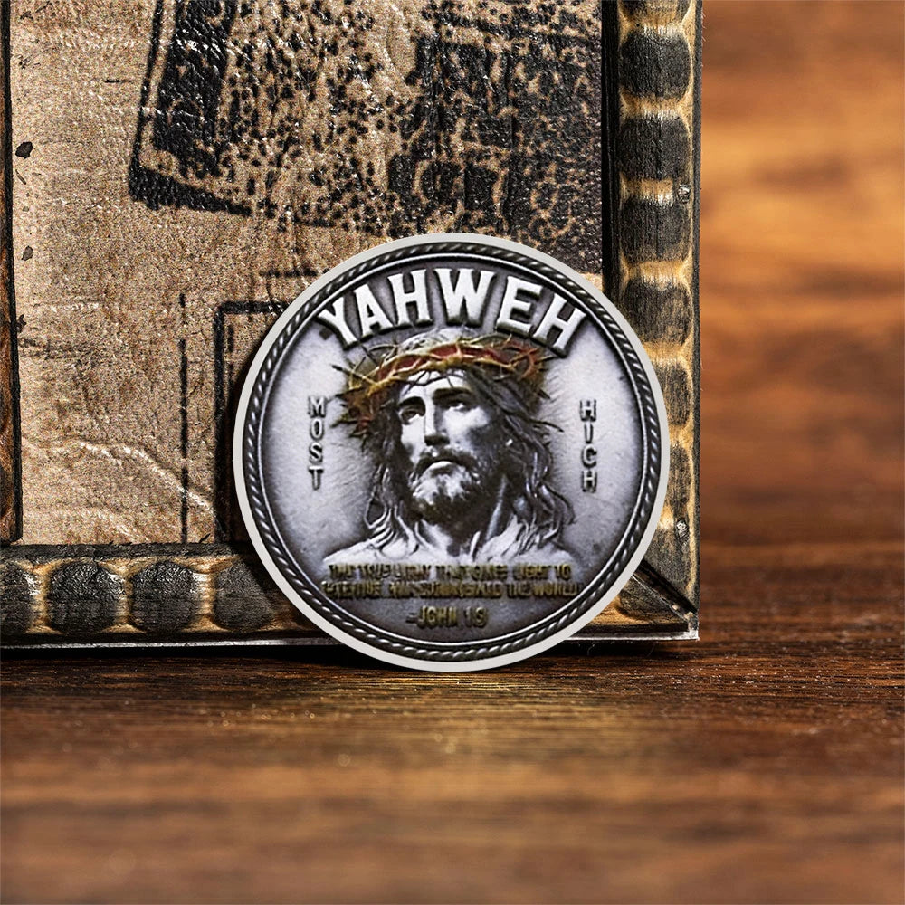 A silvery commemorative faith cross coin featuring a depiction of Jesus with a crown of thorns.