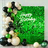 A vibrant green sequin wall backdrop decorated with clusters of gold, black, and lime green balloons for a birthday party.