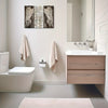 Farmhouse wing wooden frame wall art above a bathroom vanity and toilet.