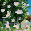 Rainbow suncatcher window stickers featuring cat, butterfly, and floral designs on a green background.