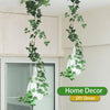 Artificial ivy garland hanging in front of a window for home decor