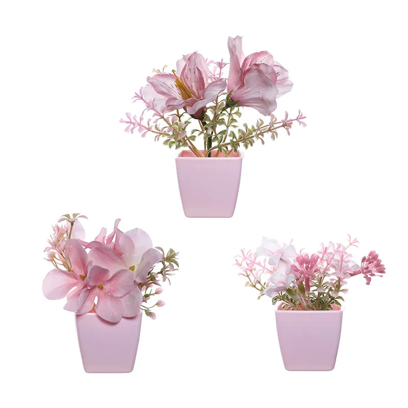 A pink flowering plant in a square pot used for home decor.