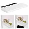 A white floating wall shelf with a black bracket, displaying small plants and decorative items.