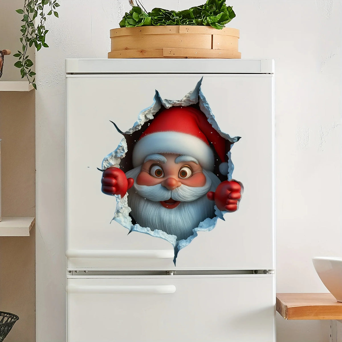 A refrigerator features a festive Christmas Santa face cutout decal on the door, with greenery in a wooden planter above.