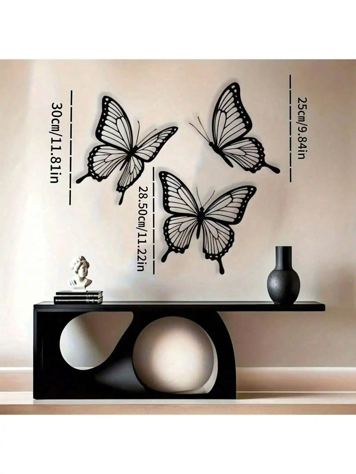 Black metal butterfly wall decor featuring various sizes and dimensions displayed above a black table.