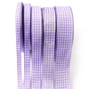 A roll of purple and white gingham ribbon for gift wrapping, crafts, or party decor.