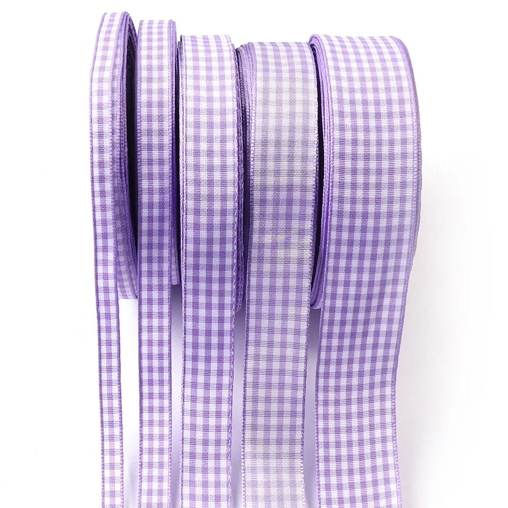 A roll of purple and white gingham ribbon for gift wrapping, crafts, or party decor.