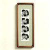 A vertical photo strip frame with a walnut wood border and a striped green and white background, displaying several portrait 