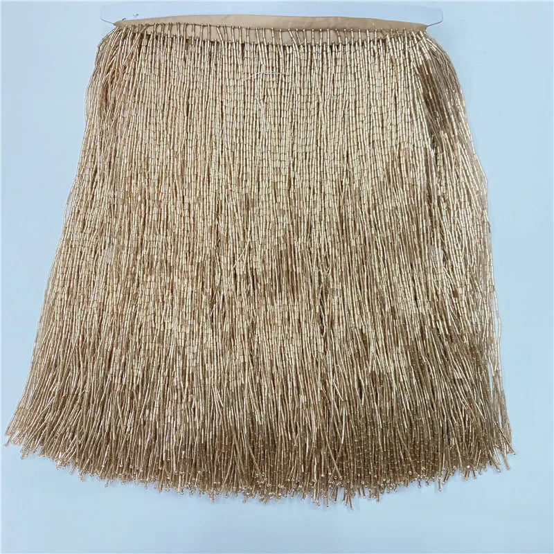 A beige decorative beaded tassel fringe trim for curtains and DIY projects.
