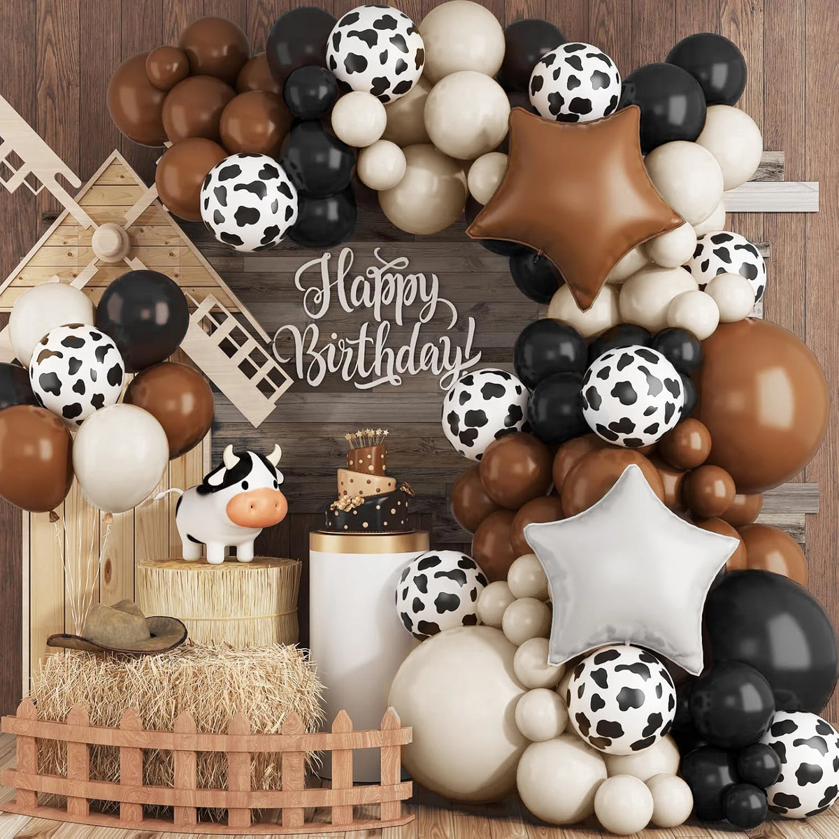 A balloon arch kit featuring various brown, white, and black polka-dot balloons arranged in a rustic farm theme display.