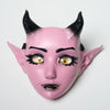 A pink fantasy creature mask with black horns and detailed eye makeup.