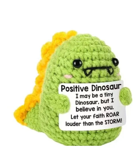 Handmade plush knitting doll shaped like a green dinosaur with yellow hair and a sign that says I may be a tiny dinosaur but 