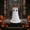 A white ghost costume stands on a wooden platform surrounded by glowing pumpkins and Halloween decorations.