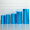 A row of six shiny blue spandex cylinder stands displayed against a white wall.