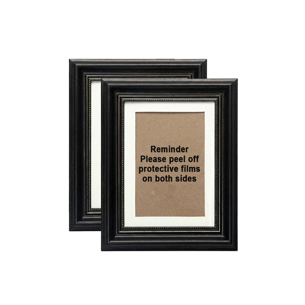 A black photo frame with an antique gold trim displaying a reminder note inside.