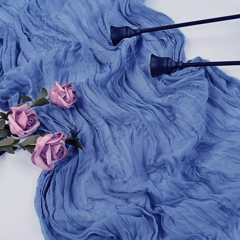A flowing blue fabric with dark purple rosebuds and black decorative elements.