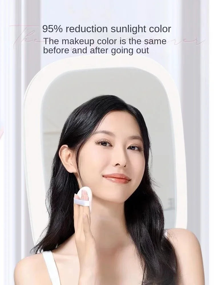 A woman looking into a vanity mirror while holding a white LED mirror accessory.