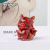 A small, reddish-orange crystal sculpture of a fox, used for Feng Shui decor.