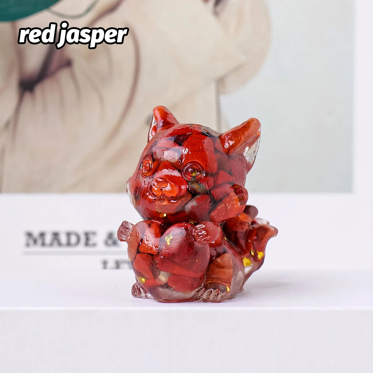 A small, reddish-orange crystal sculpture of a fox, used for Feng Shui decor.