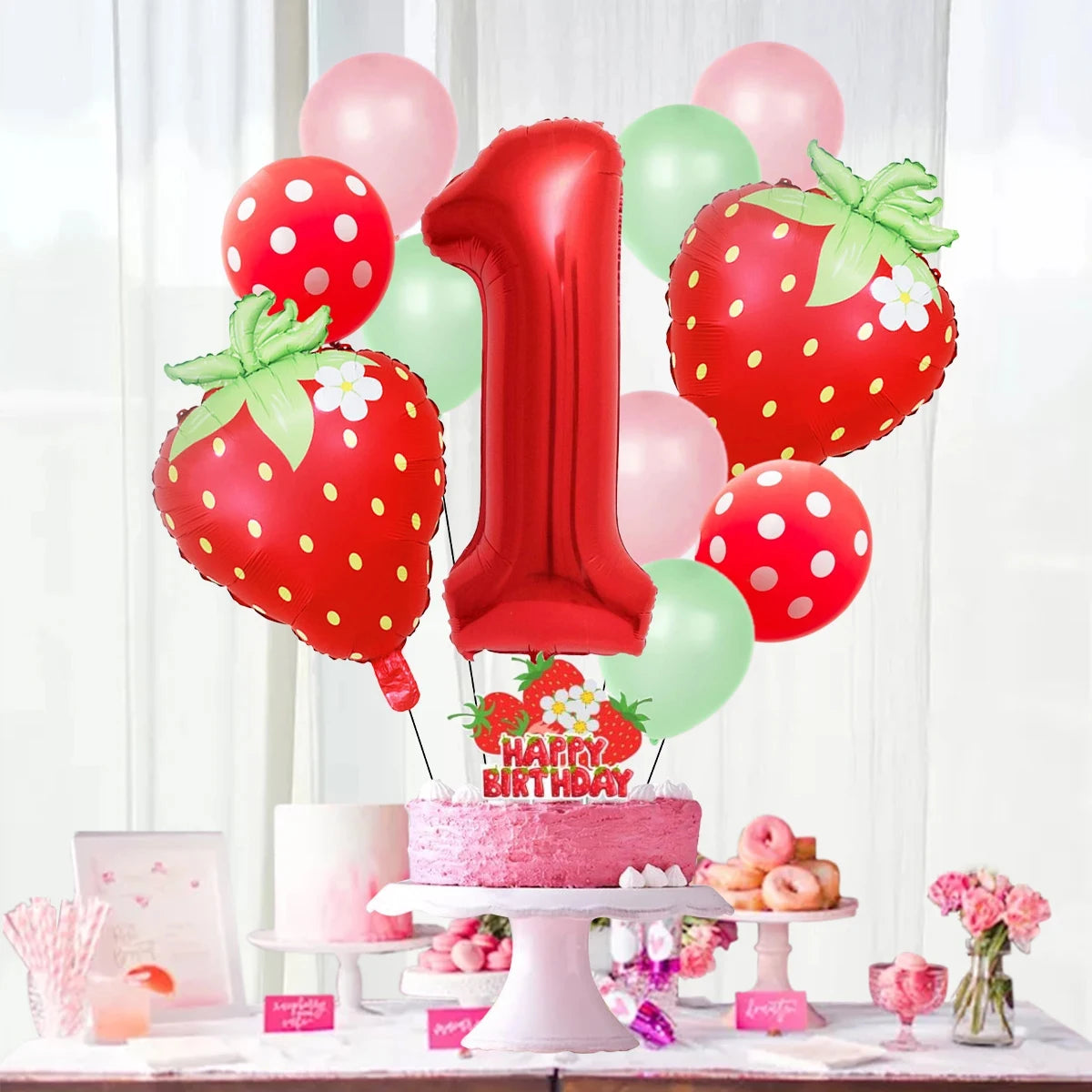 A red and pink strawberry foil balloon set featuring a large number one balloon and several round balloons.