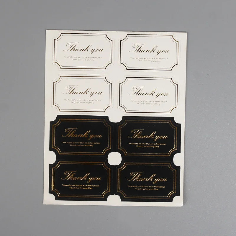 A sheet of thank you seal stickers for crafting and packaging featuring various designs.