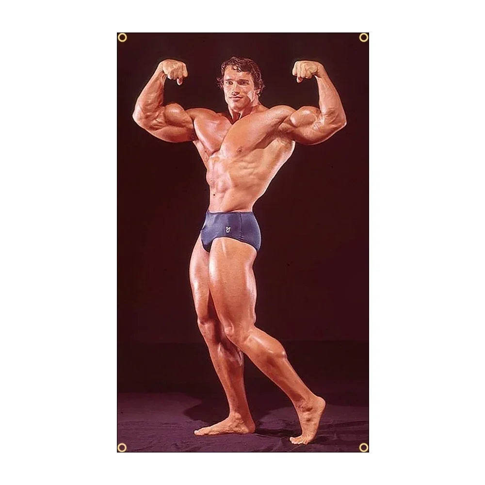 A muscular man posing with his arms flexed, wearing dark shorts, against a dark background.