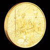 A gold-plated commemorative coin depicting a scene from the Last Supper.