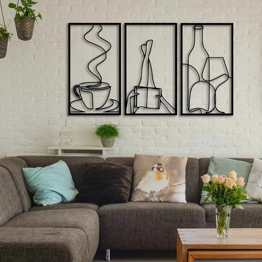 Three framed minimalist line art prints of books and literary themes on a white brick wall.