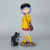 A figurine of a girl with blue hair and a black hat wearing a yellow jacket and red skirt.