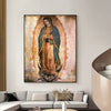 Canvas wall art depicting Our Lady of Guadalupe in a brown and blue mantle against an orange glow.