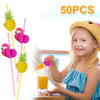 A smiling girl holds a glass of orange juice garnished with a pink flamingo and pineapple paper straw from a pack of 50.