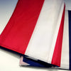 A decorative banner featuring vertical stripes of red, white, and blue fabric.