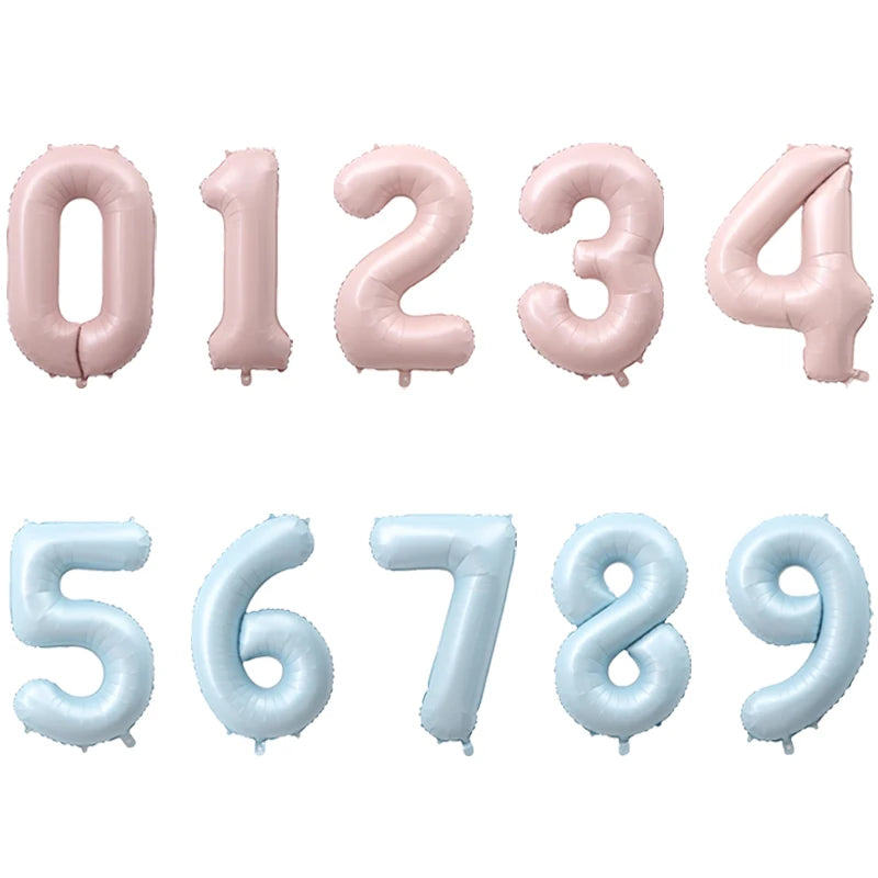 A set of pink and light blue foil number balloons forming the numbers 0 through 9.