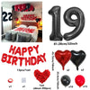 A set of red and black birthday balloons including a 19 balloon, heart shaped balloons, and a red cluster of balloons.
