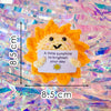 Handmade crochet orange sun doll with a card that says to brighten your day