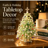 A festive tabletop decor featuring a green beaded Christmas tree with crystal accents and a cross, displayed on a wooden surf