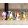 A set of four Digimon Adventure 9-Figure collectible figures standing on a wooden surface.