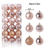 A box containing 36 festive Christmas tree ornament balls in various shades of rose gold and silver.