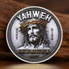 A silver commemorative coin featuring a depiction of Jesus Christ with a crown of thorns and the inscription Yahweh.