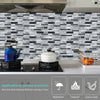A black and white marble tile backsplash featuring a Crystal Film decal for a kitchen wall.