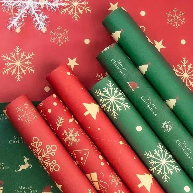 A collection of festive Christmas wrapping paper rolls in red and green with snowflake patterns.