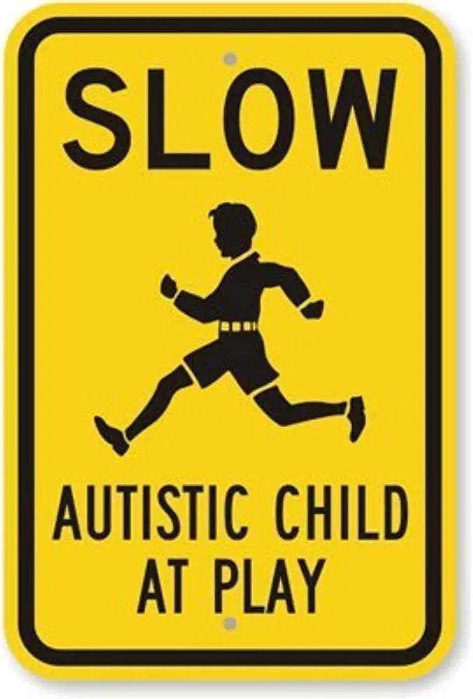 A yellow sign with black text that reads SLOW AUTISTIC CHILD AT PLAY