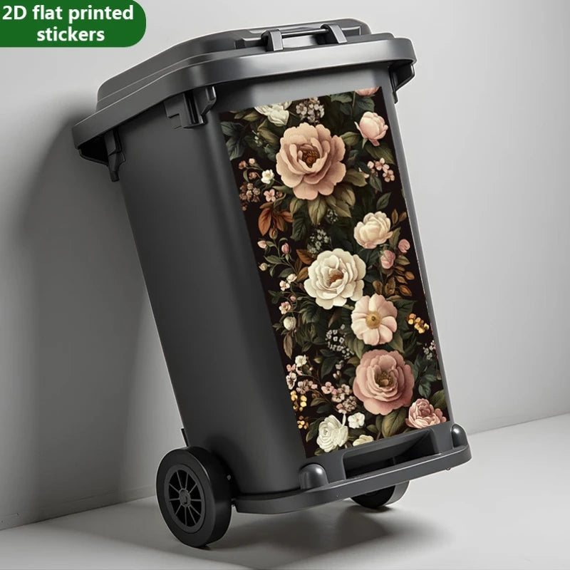 Une poubelle gris foncé avec un autocollant à motif floral sur le côté.