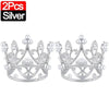 A pair of silver crown cake topper decorations.