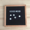A black felt letter board framed in wood displaying the text GOOD MOOD and various white emoji icons.