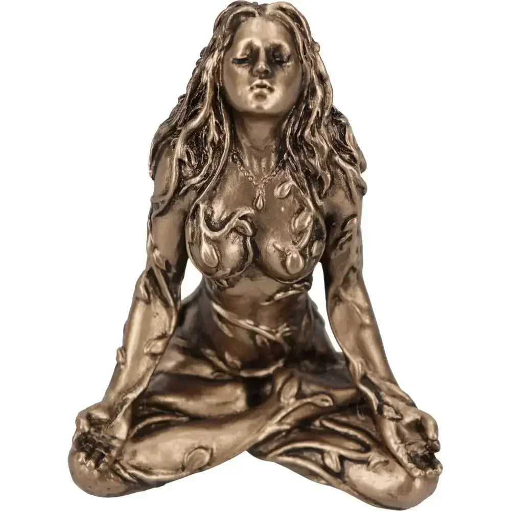 A bronze statue of a female figure with long flowing hair in a meditative pose.