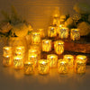 A collection of glowing yellow LED tea light candles in decorative paper lampshades arranged on a wooden surface.