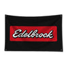 Black flag with a red rectangular patch featuring the white text Edelbrock.